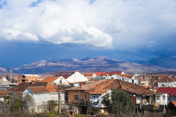 Obraz premium Roofs of Podgorica, Montenegro, mountains and evening sky with clouds