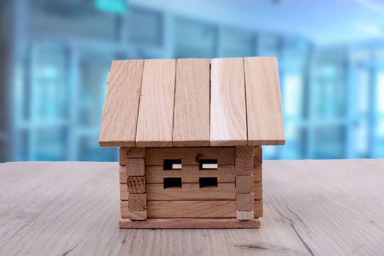 Model house on rustic wooden surface, closeup