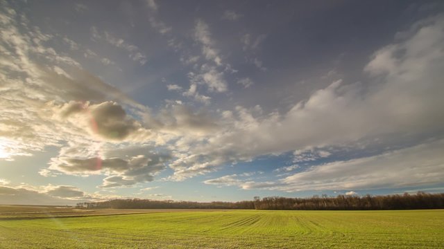 gruenes feld und viele wolken zeitraffer