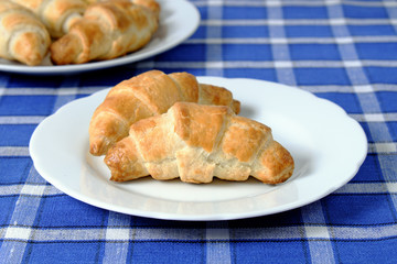 Homemade croissant on a white plate
