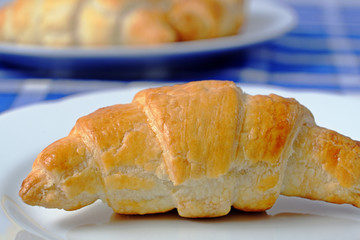 Homemade croissant on a white plate