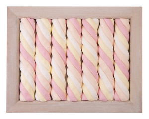 fun pale pastel colored marsh mallow candy in a wooden frame - 104312386
