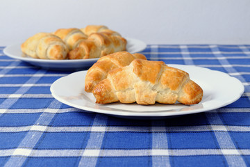 Homemade croissant on a white plate