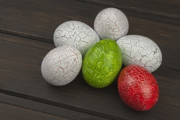 Painted eggs as a symbol of spring and new life on a wooden background. Decorations for the celebration of Easter.
