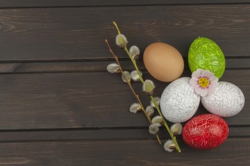 Painted eggs as a symbol of spring and new life on a wooden background. Decorations for the celebration of Easter.
