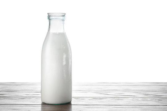 A bottle of milk on the table with isolated background