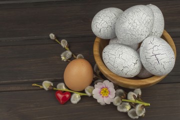 Painted eggs as a symbol of spring and new life on a wooden background. Decorations for the celebration of Easter.

