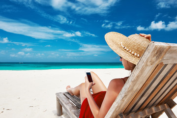 Young woman with tablet pc at the beach