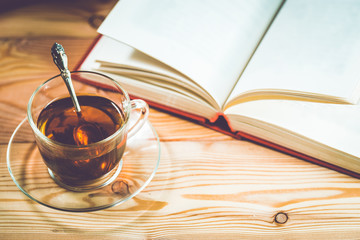 Cup of tea and books onwooden background