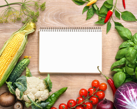 Fresh organic vegetables on a wooden background and notebook. Fresh vegetables background. Diet. Dieting. Space for your text. high resolution product