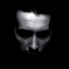 Portrait of unknown man in shadow. Black and white silhouette.