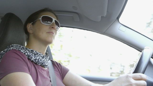 Autumn Driving - Woman is driving a car on a beautiful autumn day