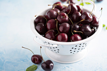 Fresh ripe sweet cherries in a colander