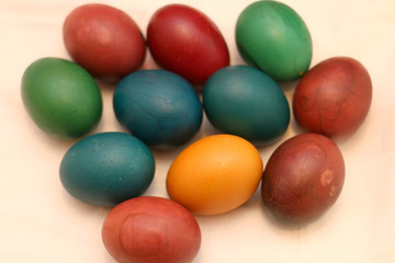 Fototapeta na wymiar PIle of colourful Easter eggs on light pink background.