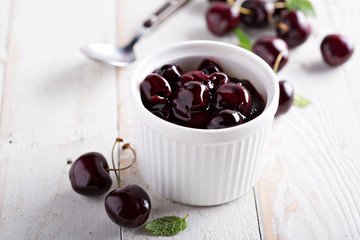 Homemade cherry sauce in white ramekin