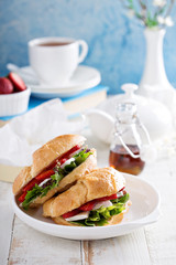 Croissant sandwich with brie, salad and strawberry