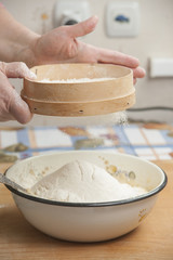 Women's hands prepairing flour before baking pie