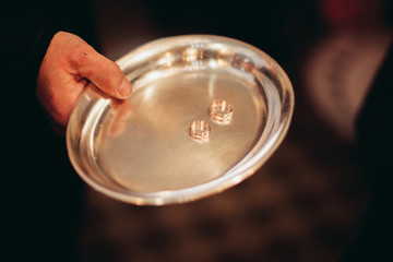 Luxurious rings in the church. Wedding ceremony