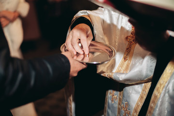 Newlyweds dress wedding ring in the church
