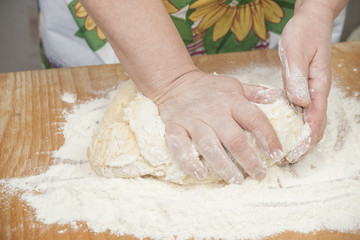 Women's hands prepairing fresh yeast dough