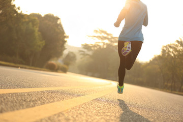young fitness woman runner athlete running at road
