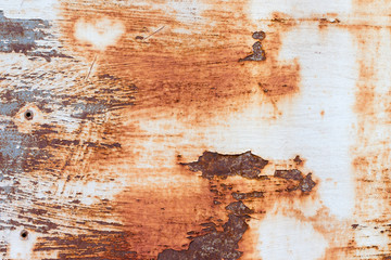 A background of peeling paint and rusty old metal