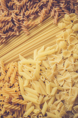 Mix of pasta on an old wooden table