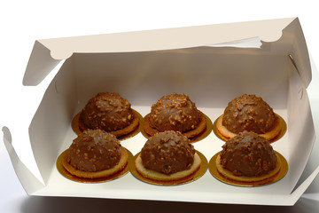 Cakes in box. Six cakes in a paper box over white background
