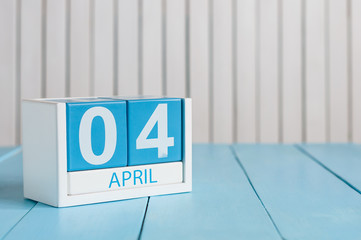 April 4th. Image of april 4 wooden color calendar on white background.  Spring day, empty space for...