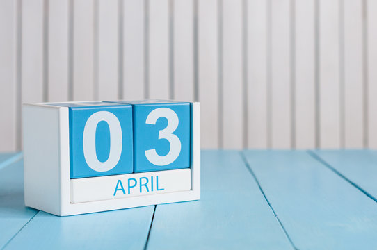 April 3rd. Image of april 3 wooden color calendar on white background.  Spring day, empty space for text
