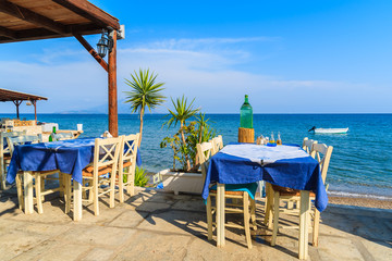 Typical Greek tavern in small fishing village on coast of Samos island, Greece