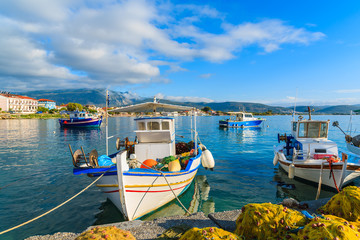 Fototapeta na wymiar Greek fishing boats in port at sunrise, Samos island, Greece