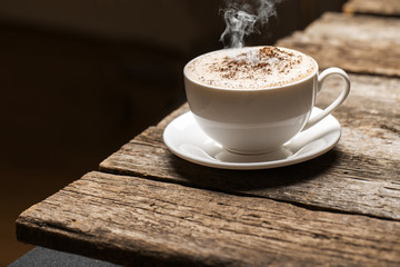 Close-up of coffee cup  on wooden background.