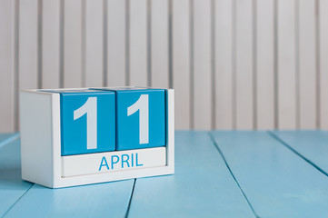 April 11th. Image of april 11 wooden color calendar on white background.  Spring day, empty space for text. International Day Of Fascist Concentration Camps Prisoners Liberation