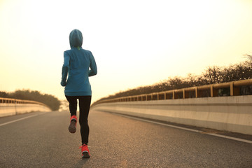 young fitness woman trail runner running  on city road