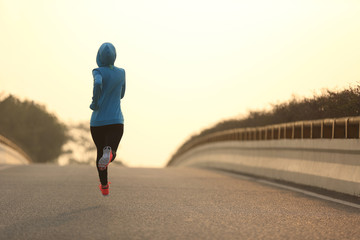 Fototapeta na wymiar young fitness woman trail runner running on city road