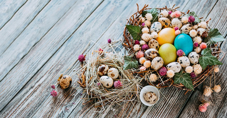 Easter composition of  Easter eggs in the nest on the old wooden background. Retro vintage style. Soft focus