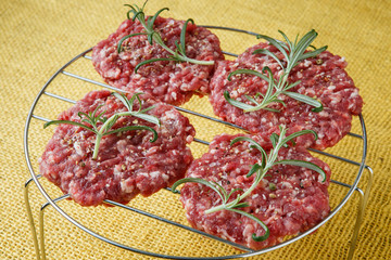 Raw minced hamburger meat with herb and spice prepared for grill