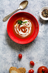 tomato cream soup in red bow, grunge background