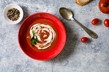tomato cream soup in red bow, grunge background