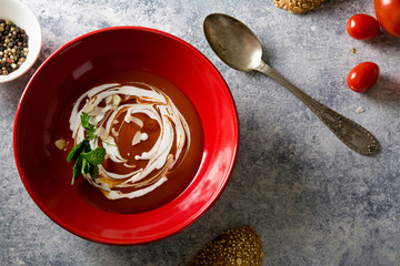 tomato cream soup in red bow, grunge background