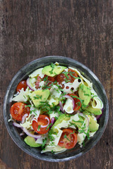 Salad with avocado, cheese, tomato and red onion