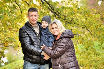 Fototapeta premium Happy family in autumn park near lake