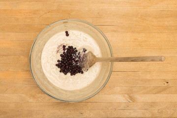 Mixing bowl with mixture and blueberries