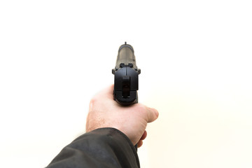 Hand gun taking aim from the side