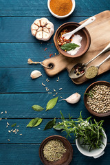 culinary background with spices on wooden table