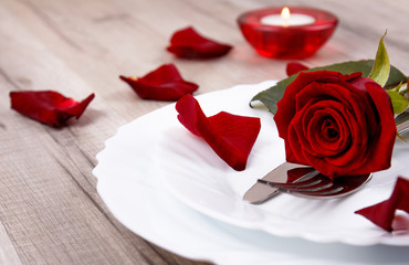 Valentines day table setting with plate, knife, fork, and red rose. Valentines day background