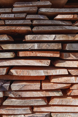 Background of dry chopped firewood logs stacked up on top of eac