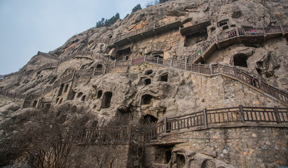 Buddha sculpture on cave wall in Longmen Grottoes (Longmen Caves