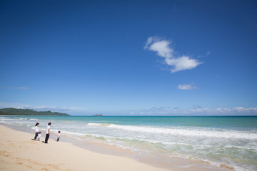 海でリラックスする四人家族